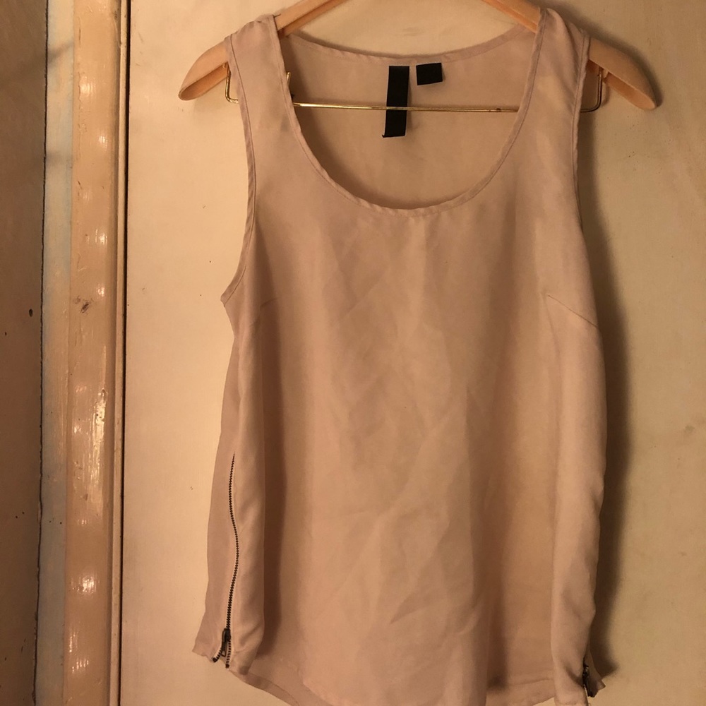 Cute very light pink top with zippers on the side